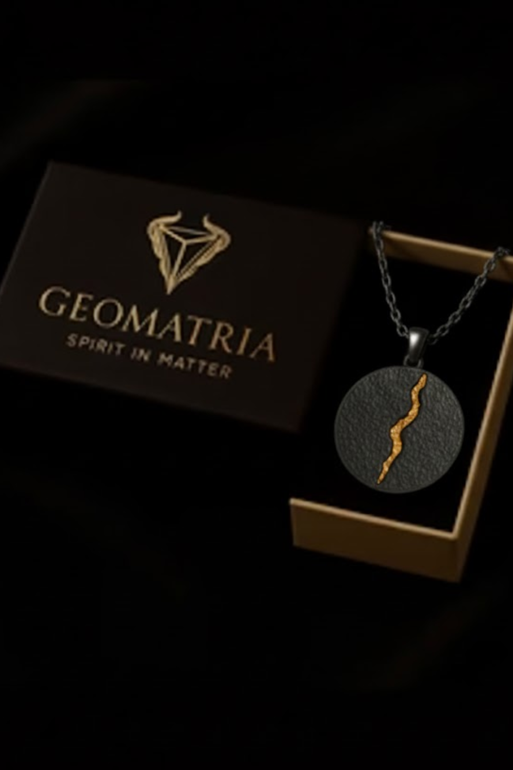 a necklace with a pendant, displayed in a wooden box with the text "Geomatria Spirit in Matter" printed on it.