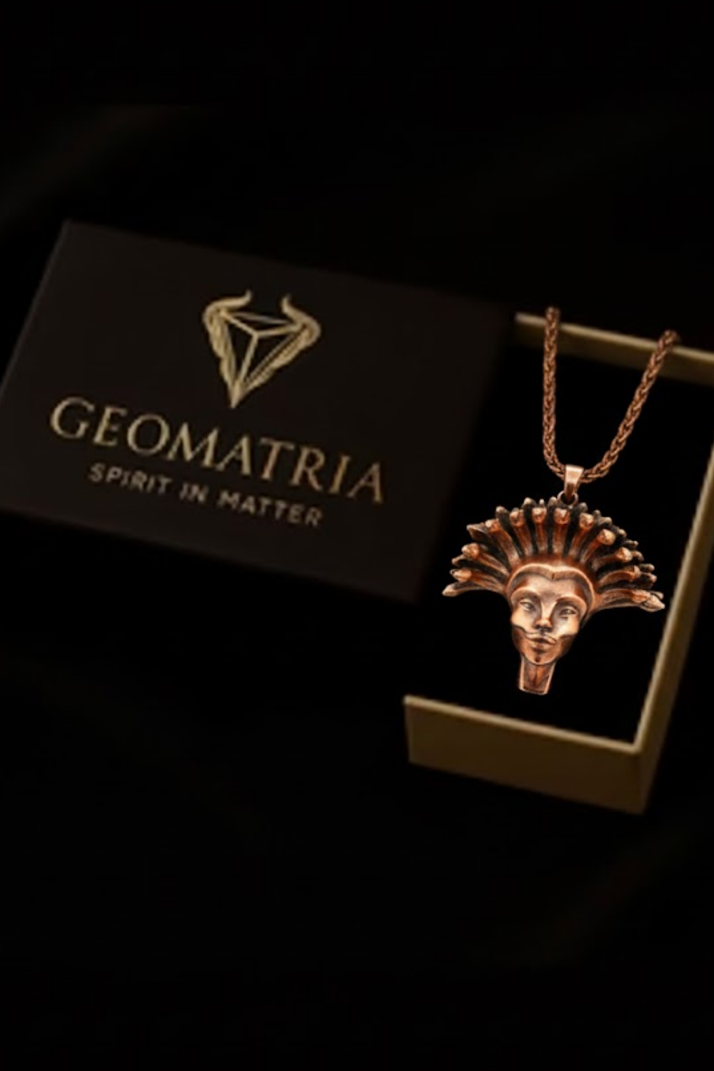 a necklace with a pendant, displayed in a box with the text "Geomatria Spirit in Matter" printed on it.