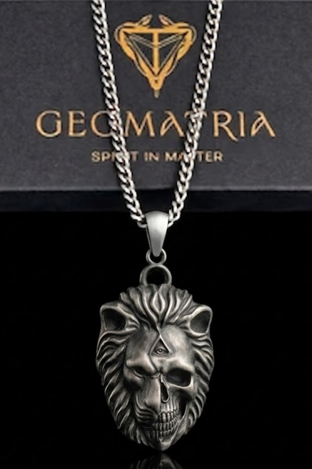 A silver-toned pendant featuring a skull design with a lion's head, suspended from a chain.