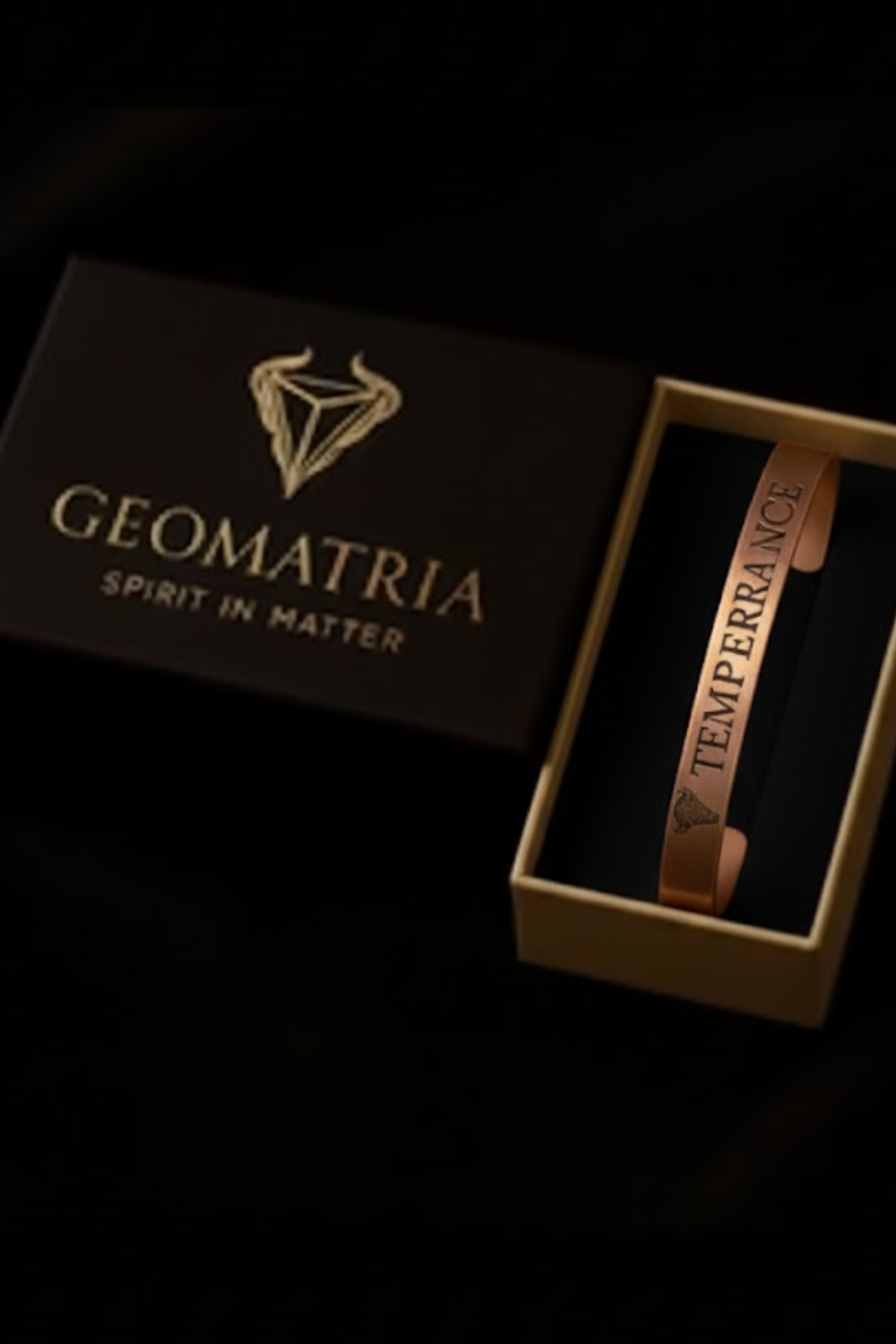 A bracelet is displayed in a box with the text "Geomatria Spirit in Matter" printed on it.