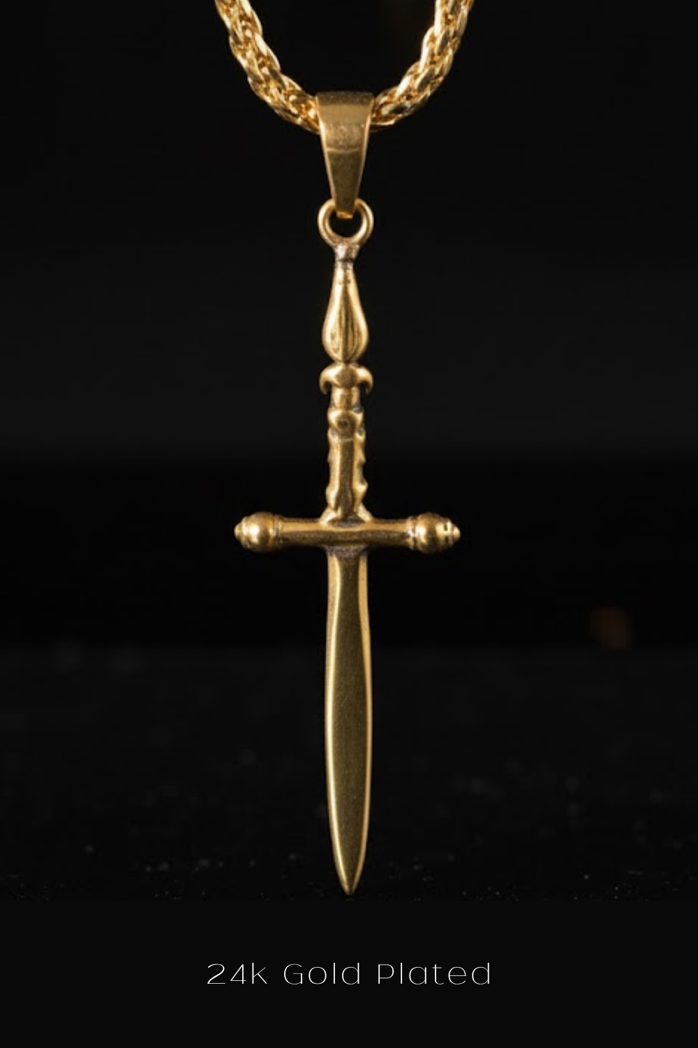 A 24k gold-plated pendant in the shape of a sword is shown against a black background.
