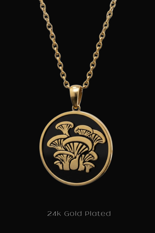 A gold-plated pendant necklace with a circular design featuring a mushroom motif.