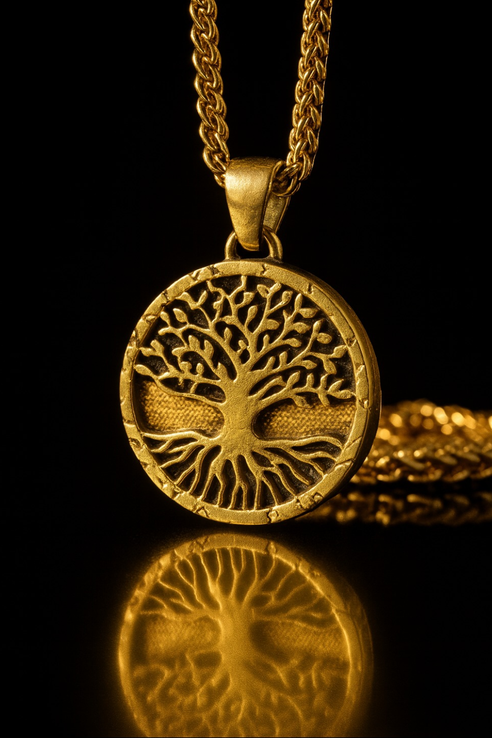 A gold-colored pendant with a tree design, suspended from a chain against a black background.