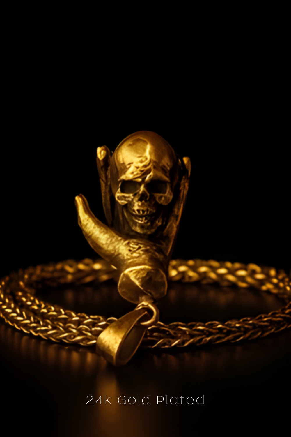 A close-up view of a gold-plated pendant featuring a skull design, with a chain around it.