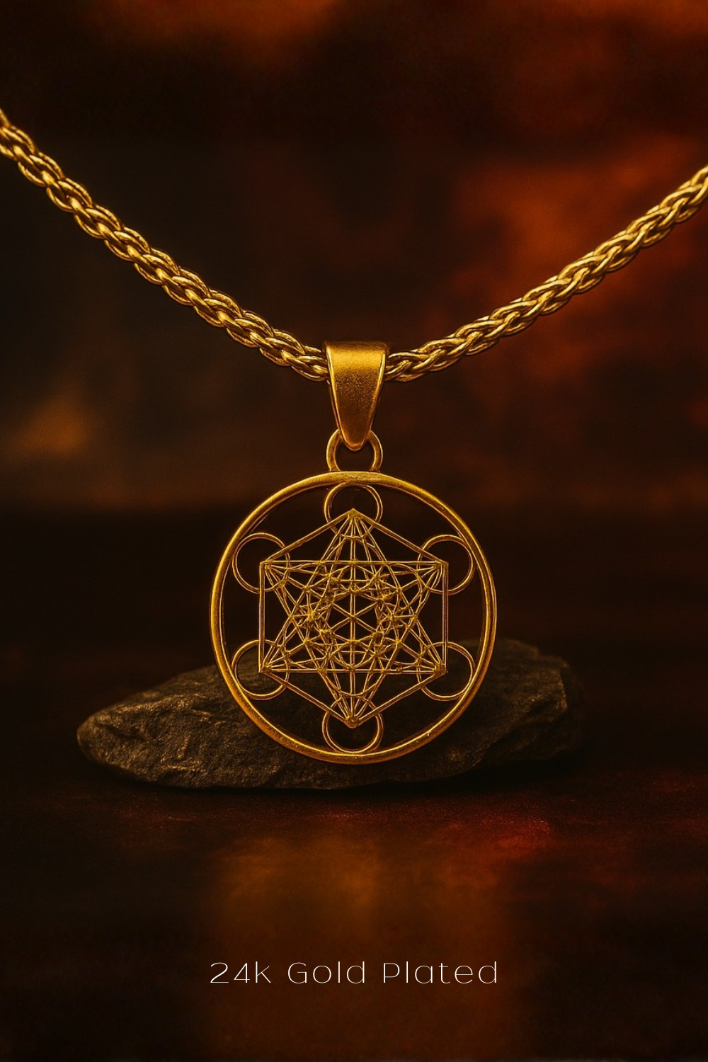 A 24k gold-plated pendant necklace with a geometric design, displayed on a dark background.