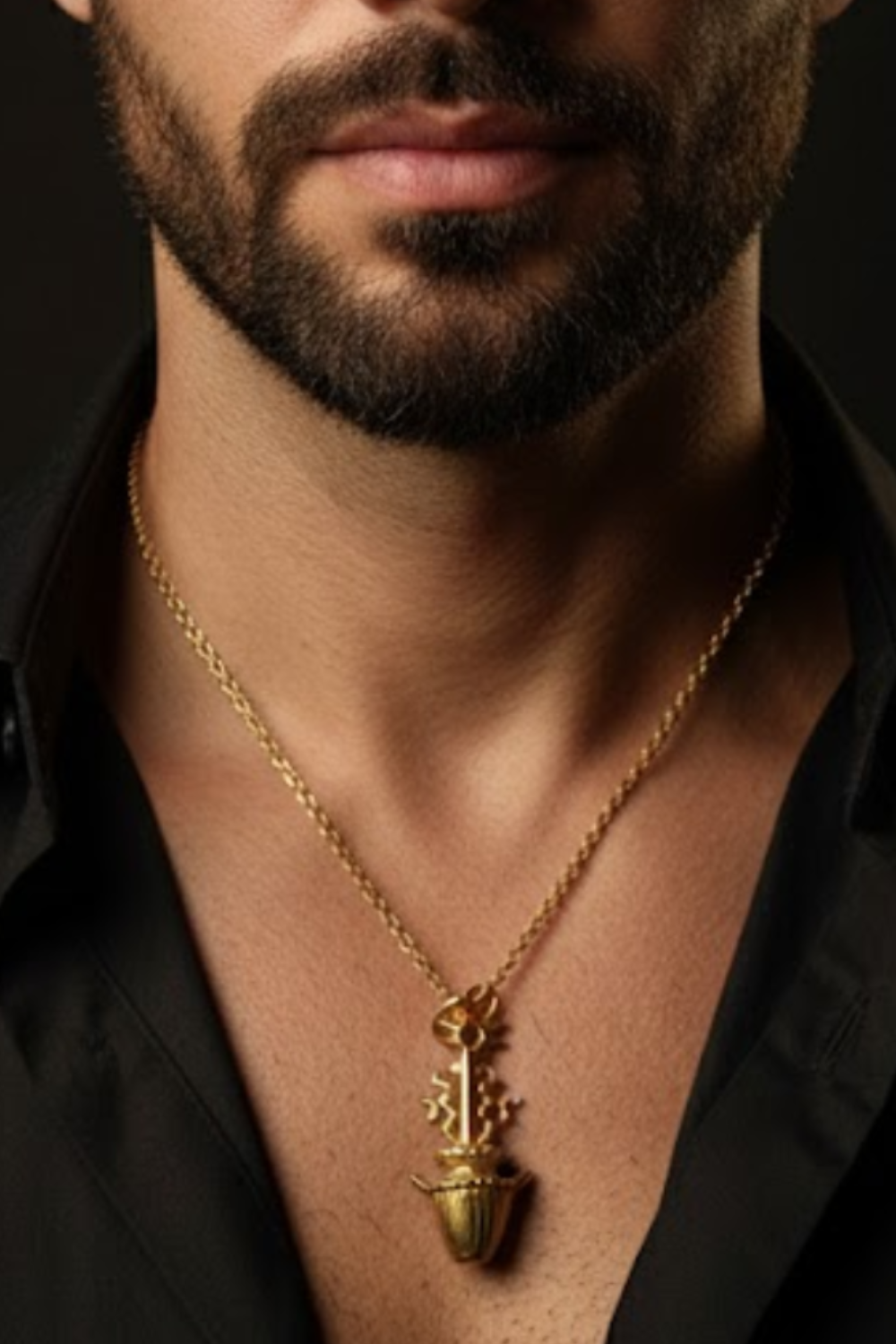 A close-up of a man's neck and chest area, with a gold necklace featuring a pendant hanging from the man's neck.