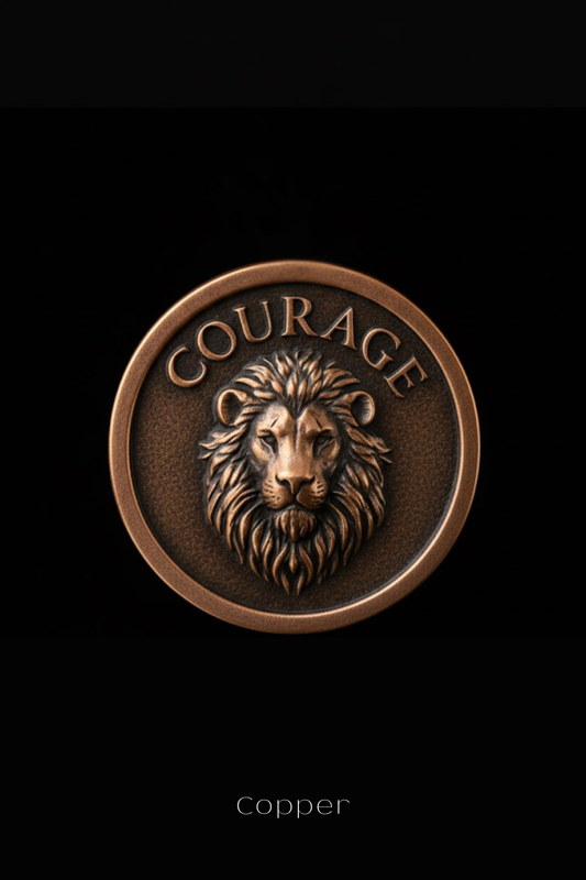 a close-up of a bronze lion's head on a circular background with the word "COURAGE" inscribed above it.