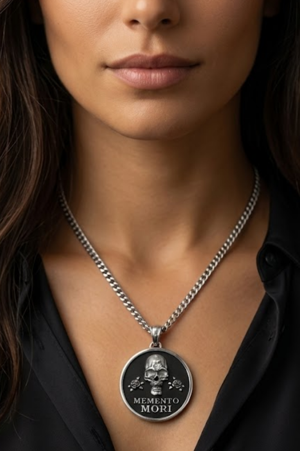 A woman wearing a silver necklace with a large pendant featuring a skull and the text "MEMENTO MORI" (Memento mori).