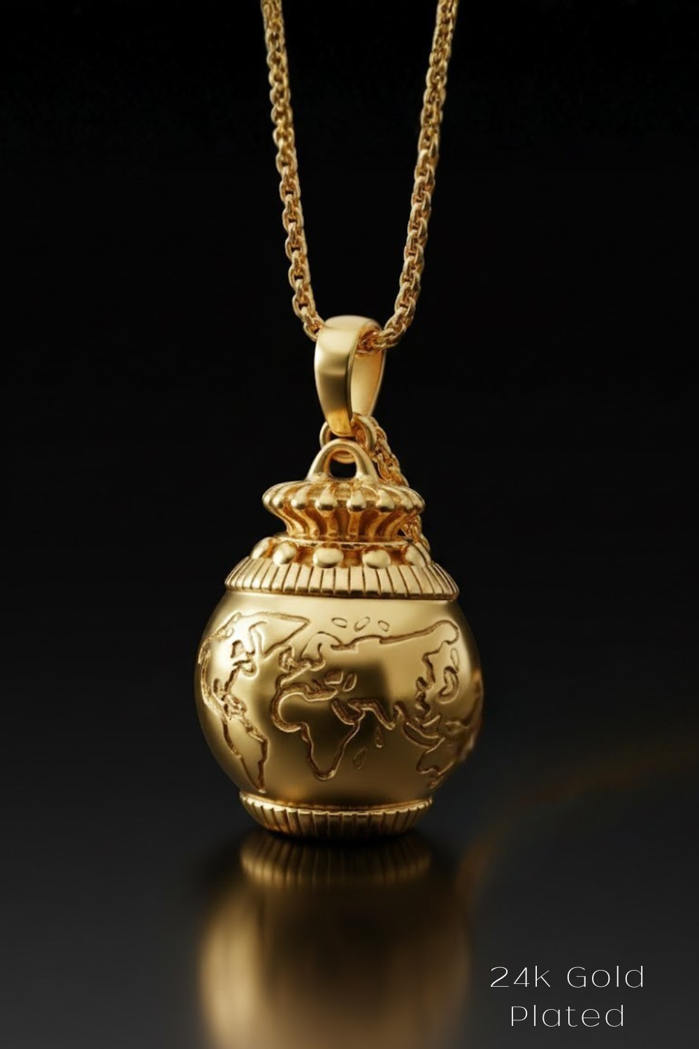 A 24k gold-plated pendant in the shape of a globe, suspended from a chain against a black background.