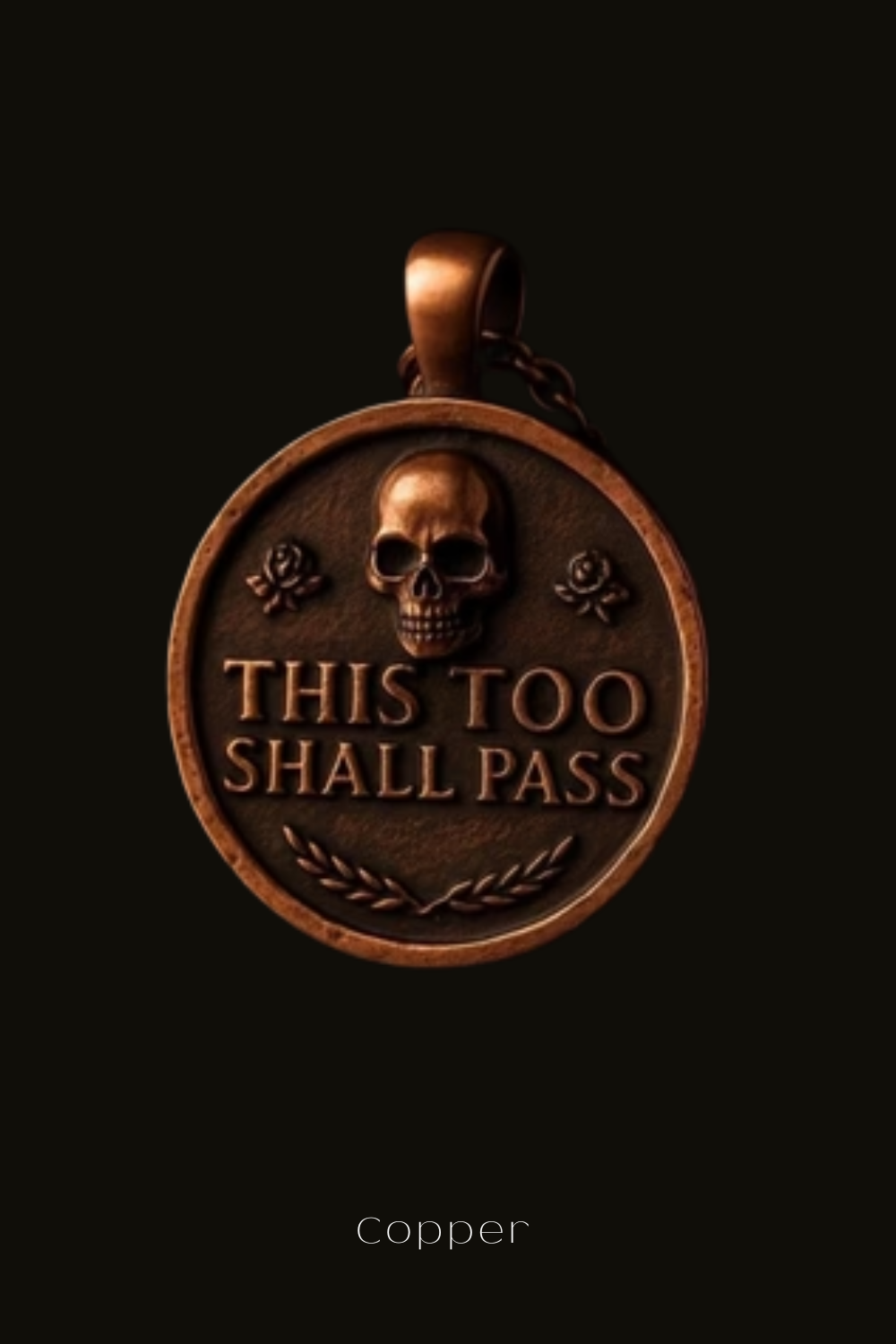 a round, copper-colored pendant with a skull and rose design, and the text "This too shall pass" engraved on it.