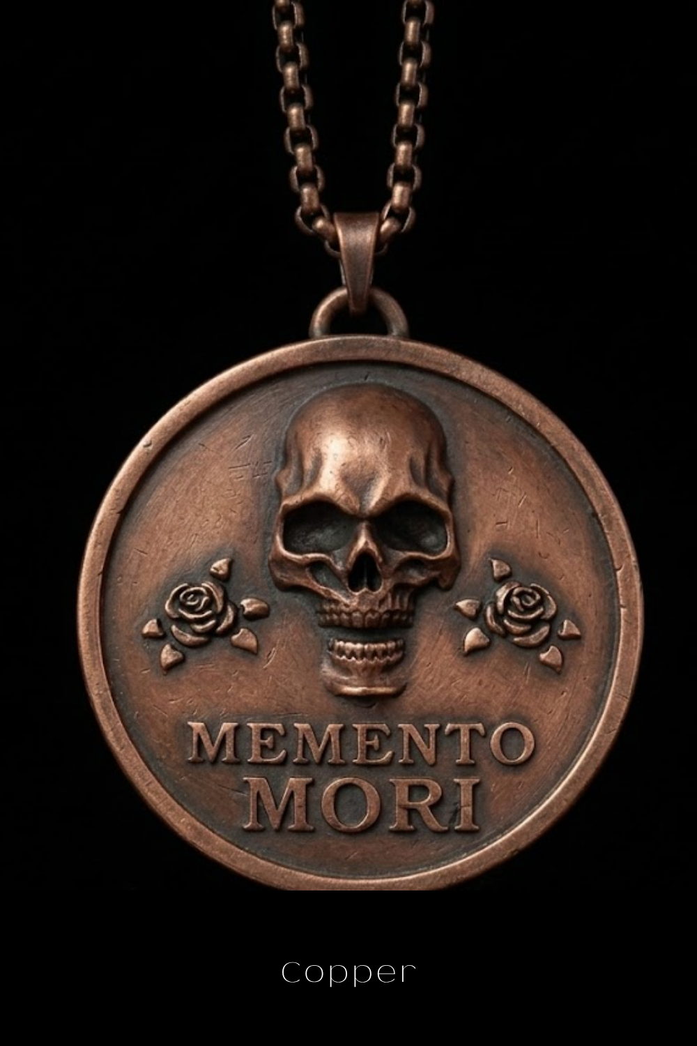 A copper-colored pendant necklace with a circular medallion featuring a skull and two roses, along with the Latin phrase "Memento mori" (which means "Remembering the dead" in English).