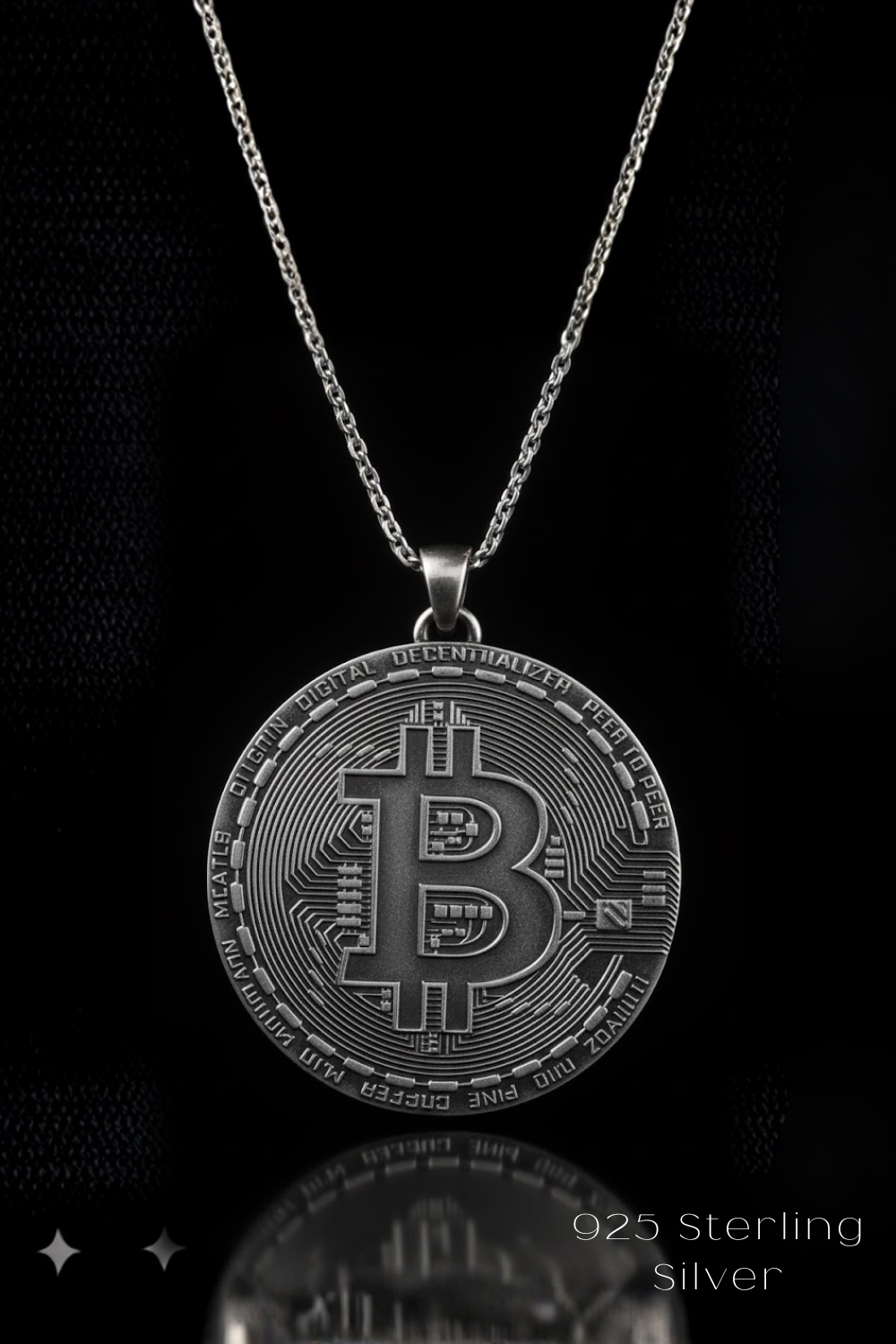 A silver-colored pendant necklace with a large, intricate Bitcoin coin design.