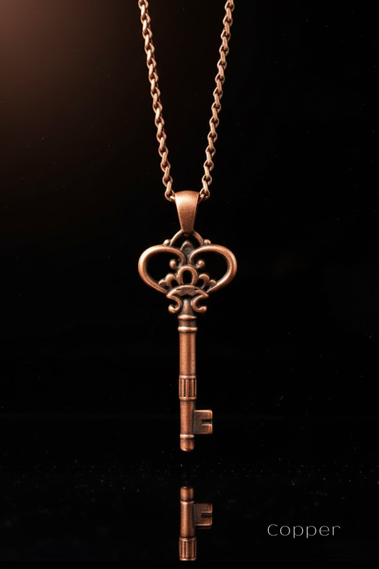 A copper-colored pendant necklace with an ornate key-shaped pendant is displayed against a black background.