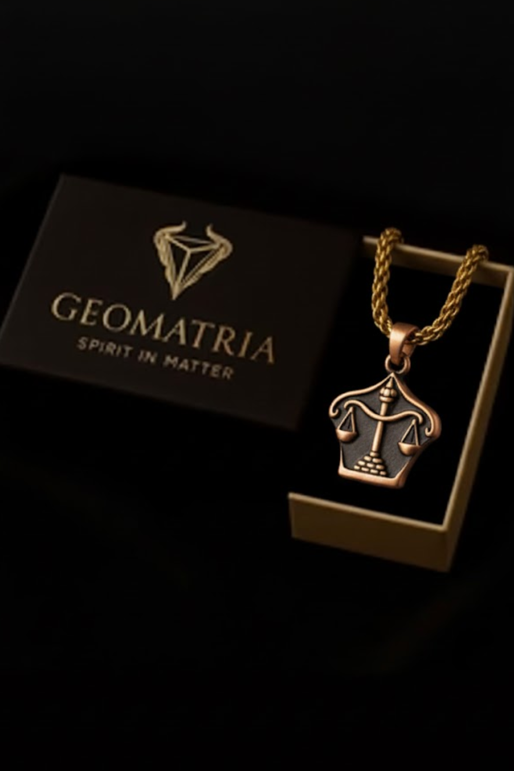 A necklace with a pendant is displayed in a box with the text "Geomatria SPIRIT IN MATTERS" printed on it.
