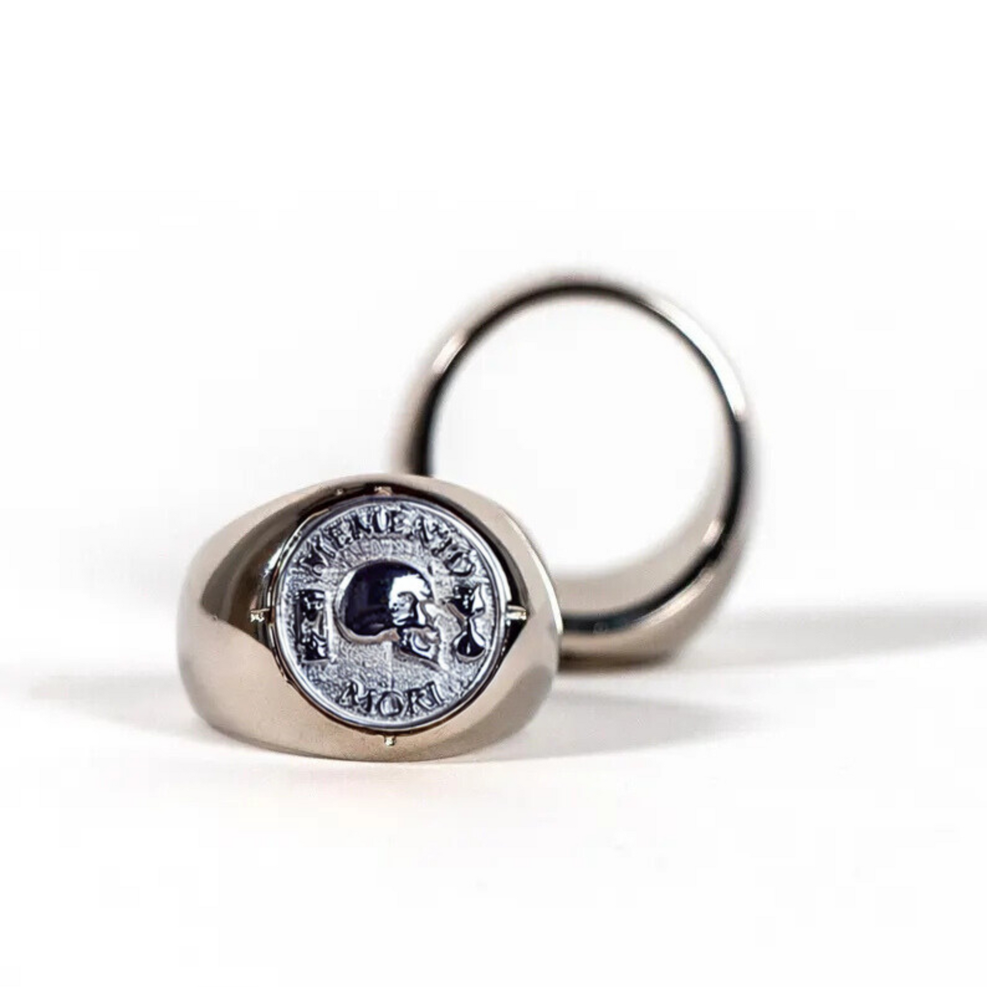 two silver rings with a skull design on them.