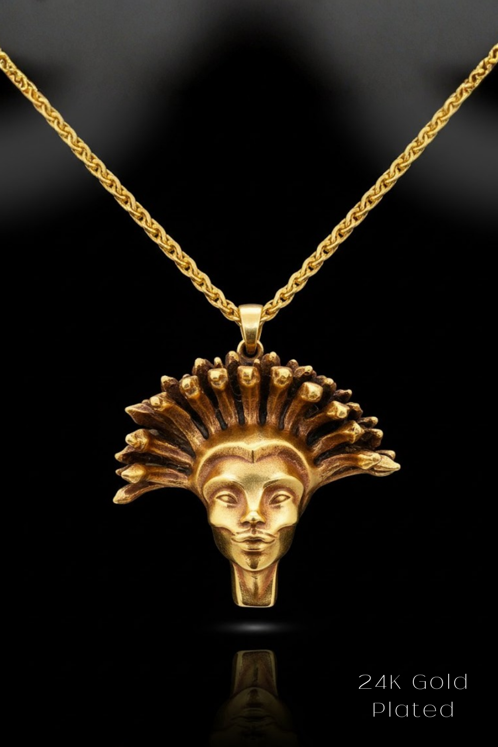 A 24K gold-plated pendant featuring an intricate design of a stylized human face with a crown-like headdress.