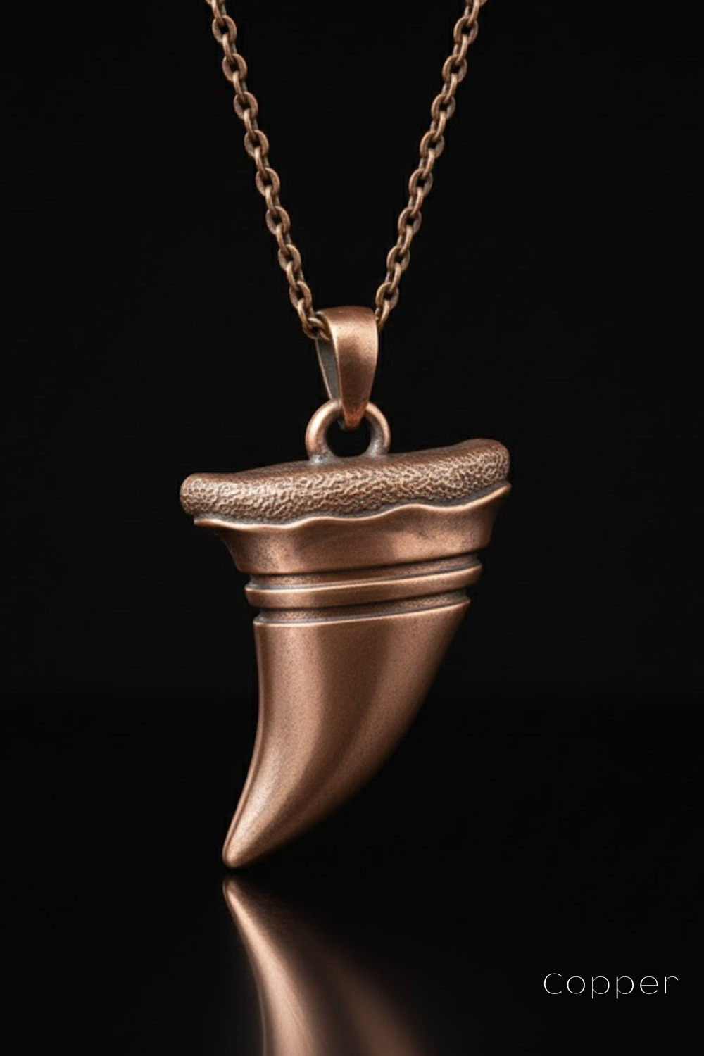A copper-colored pendant necklace with a unique, textured design.