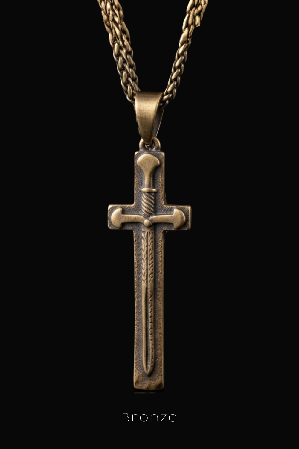 A bronze cross pendant with a sword design, suspended from a chain against a black background.