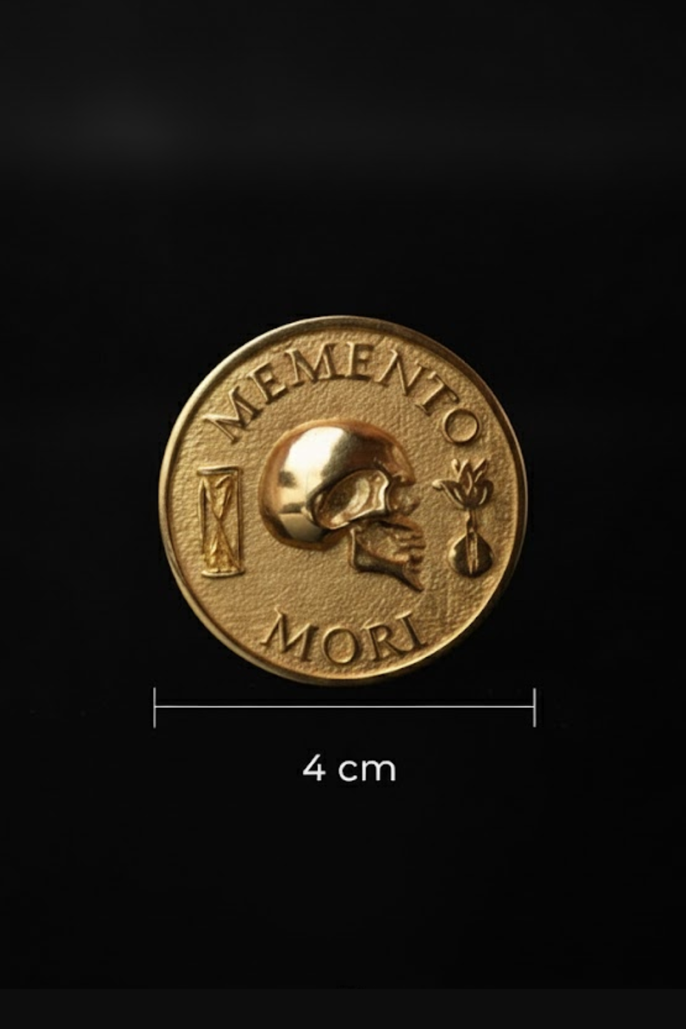 a gold-colored coin with the Latin phrase "MEMENTO MORI" (Memento mori) embossed on it.