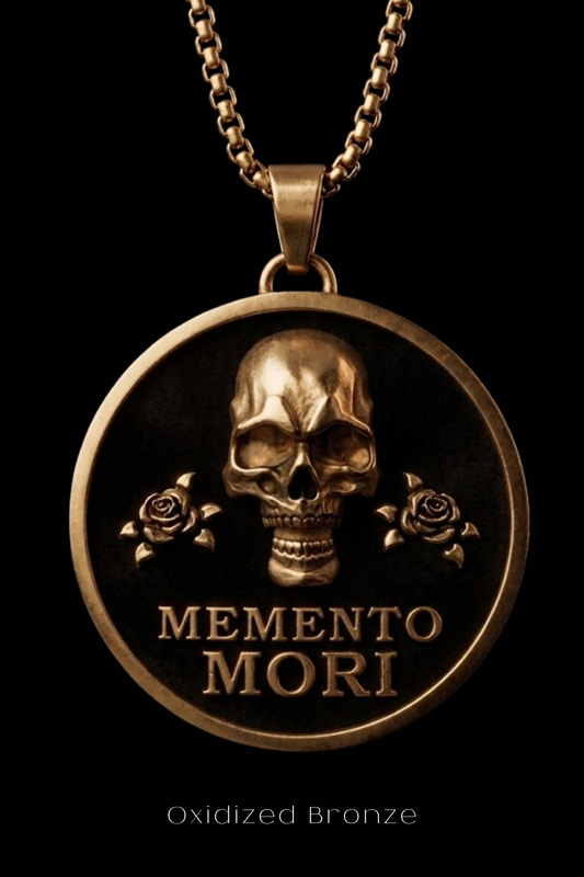 a large, round, gold-colored pendant with a skull design and two roses on either side. The pendant has the text "MEMENTO MORI" inscribed on it.
