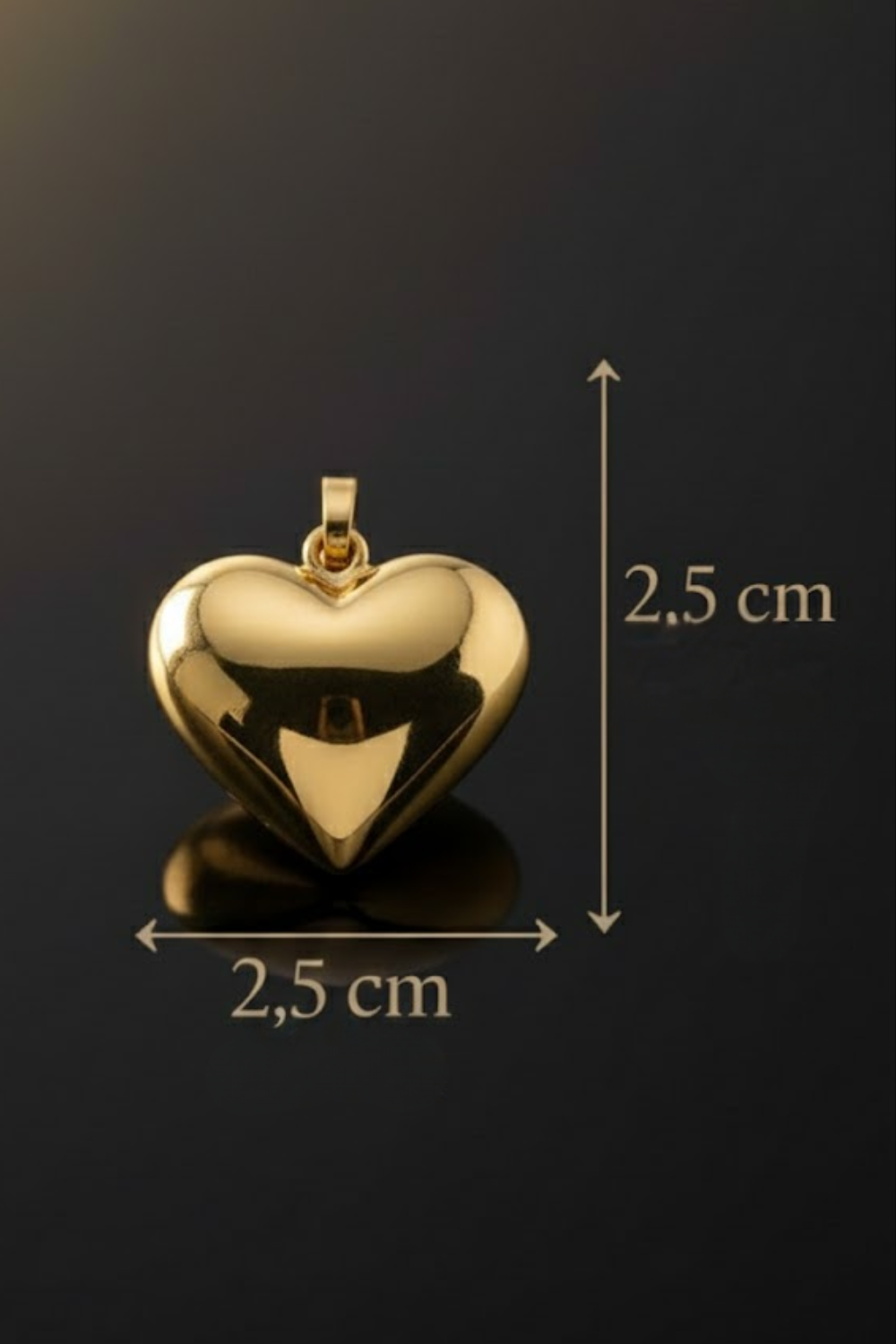 A shiny gold heart-shaped pendant is shown against a dark background, with measurements indicating its size.