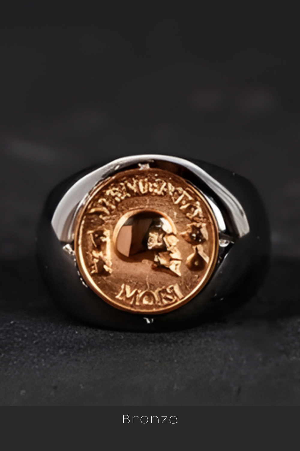 A close-up image of a ring with a gold-colored emblem featuring a skull and the word "MONT" engraved on it.