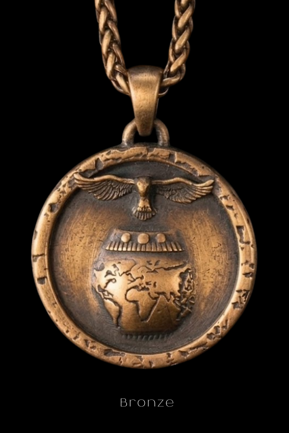 A bronze pendant with a bird and a globe design, suspended from a chain.