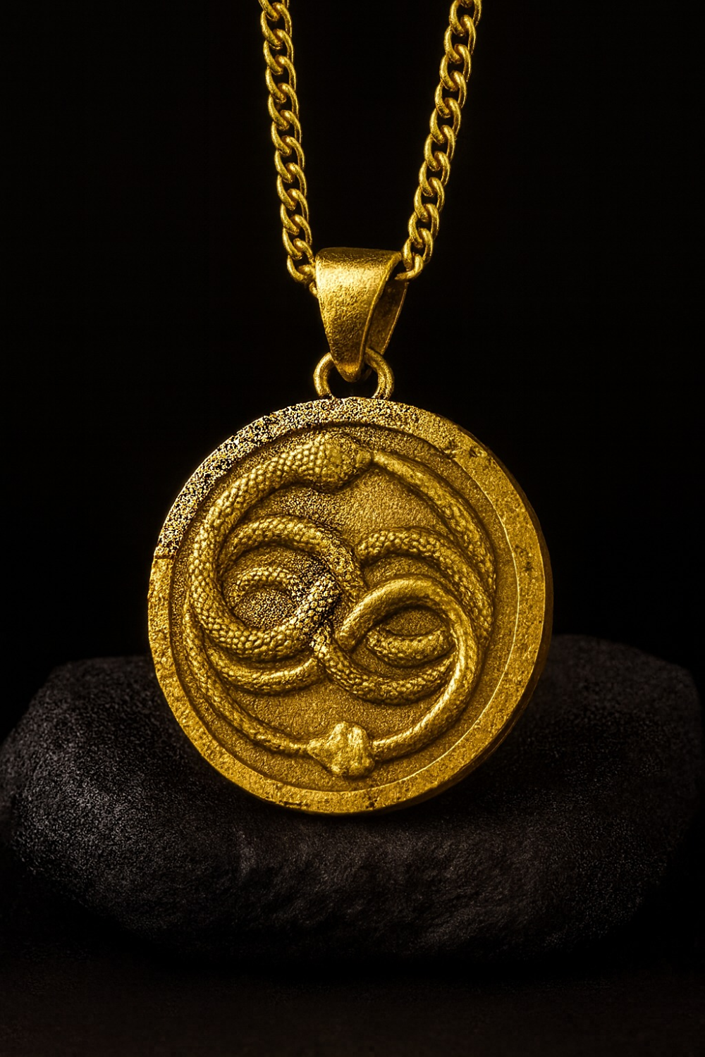 A gold-colored pendant necklace with a circular medallion featuring a snake design.