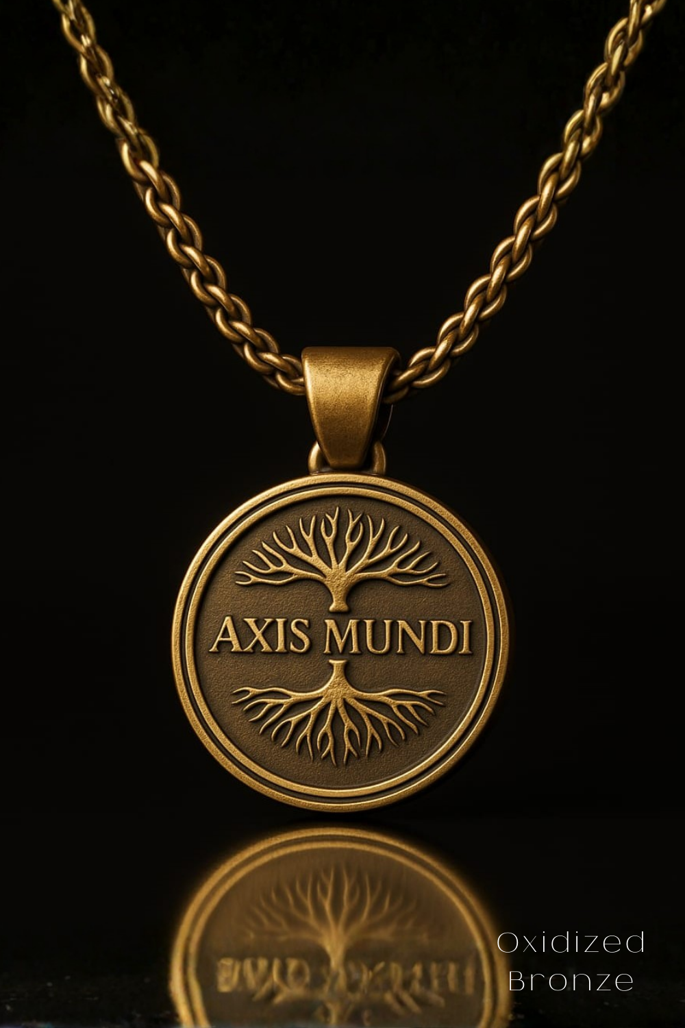 A gold-colored pendant necklace with a circular medallion featuring the text "AXIS MUNDI" and a tree-like design.