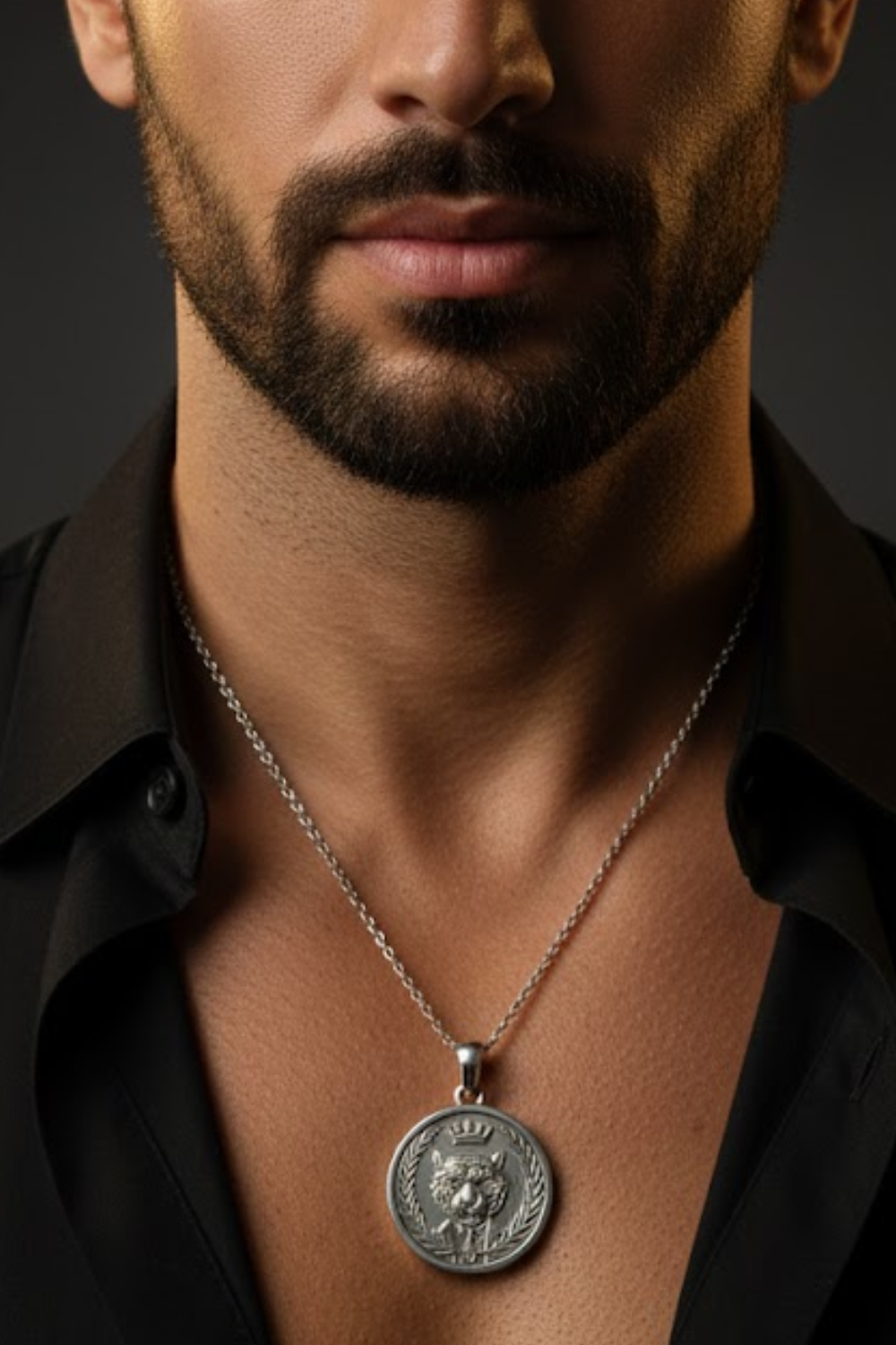 A close-up of a man's neck and chest area, with a silver necklace featuring a large pendant around his neck.