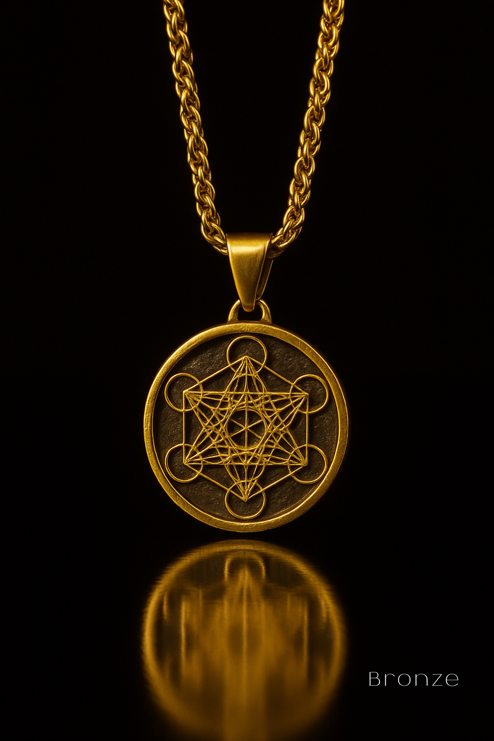 A gold-colored pendant necklace with a circular medallion featuring a geometric design, suspended from a chain against a black background.