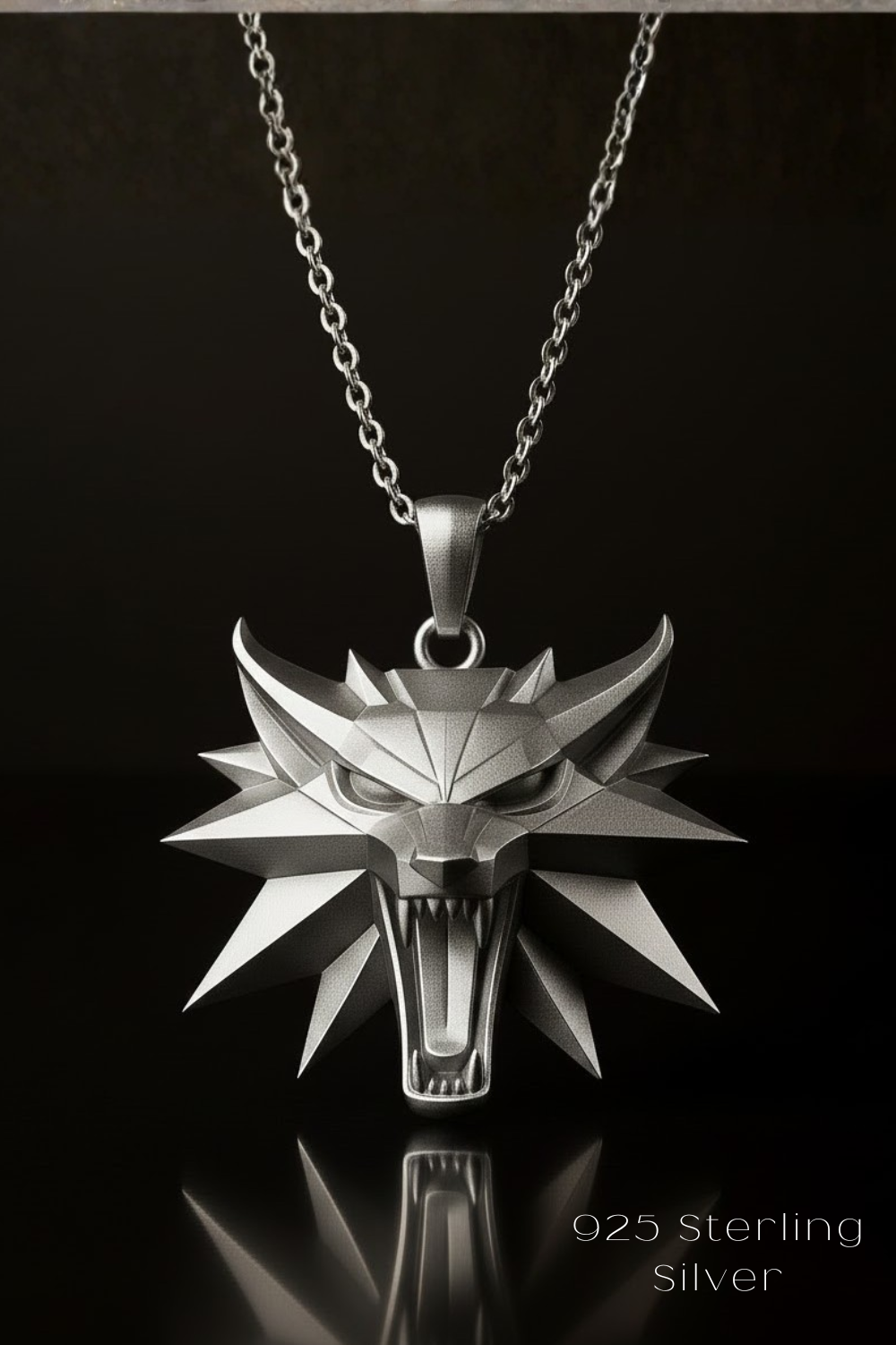 A silver pendant necklace with a wolf head pendant against a black background.