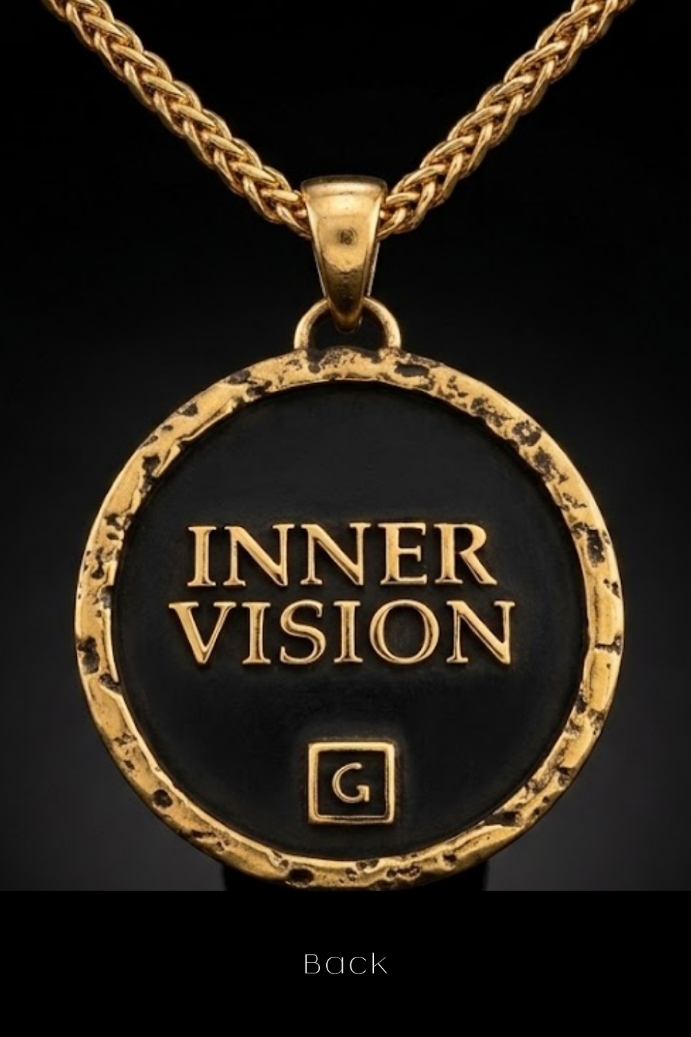 A gold-colored pendant necklace with a black circular pendant that says "INNER VISION" in gold lettering.