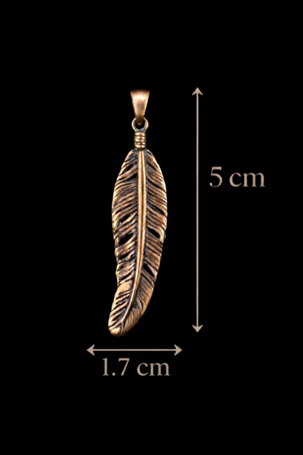 A close-up image of a gold-colored pendant in the shape of a feather against a black background.