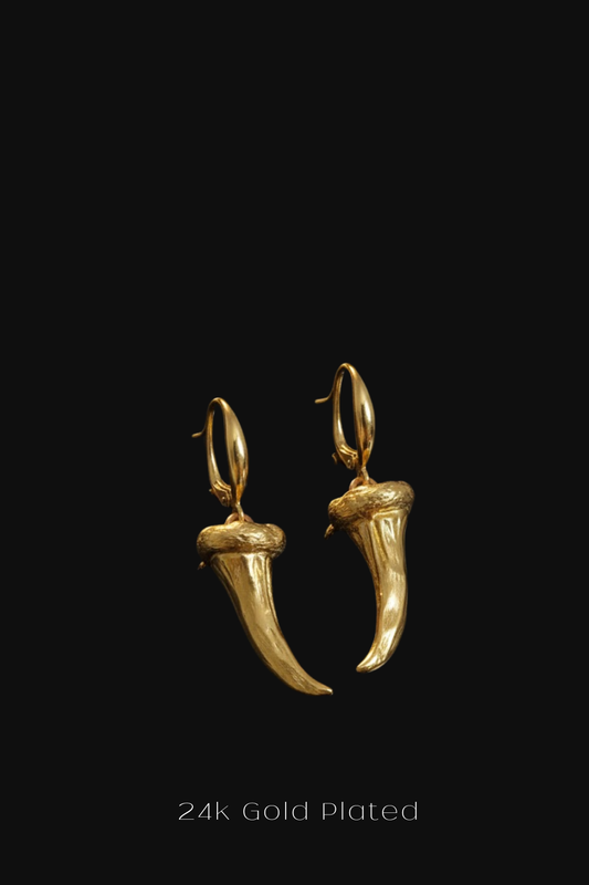 A pair of 24k gold plated earrings with a unique design, displayed against a black background.