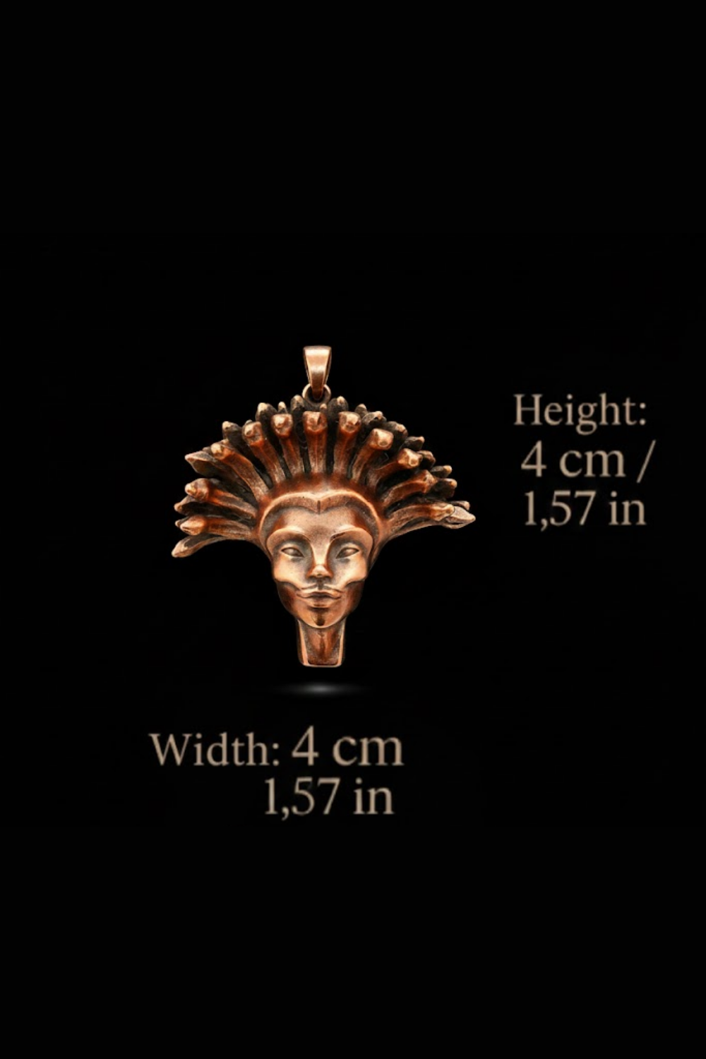 a pendant in the shape of a head with a crown-like design, set against a black background.