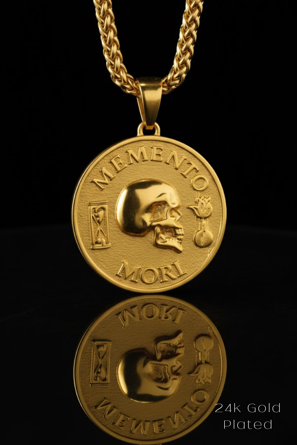 A 24K gold-plated pendant necklace with a medallion featuring a skull and the Latin phrase "Memento mori" (which means "Remembering the dead" in English).