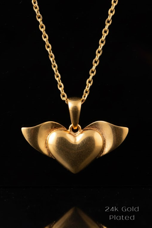 A 24K gold plated pendant necklace with a heart-shaped pendant featuring wings.