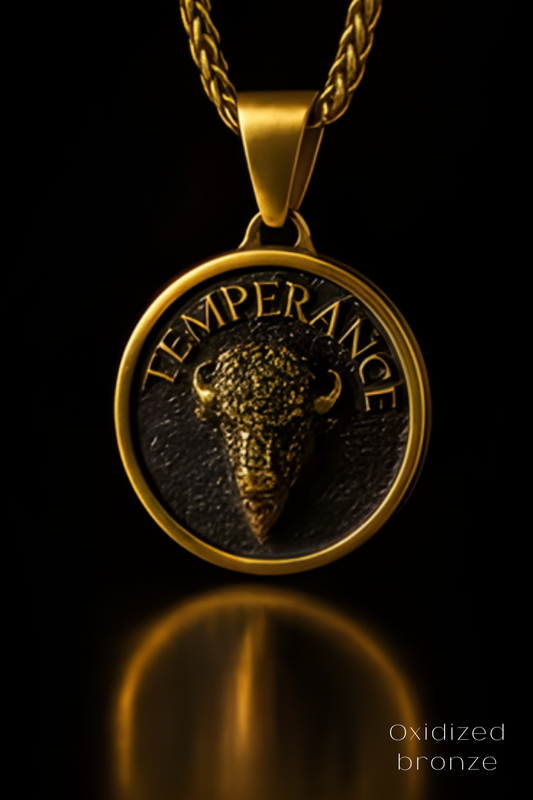 A gold-colored pendant with a bull's head design, featuring the word "TEMPERANCE" inscribed on it.