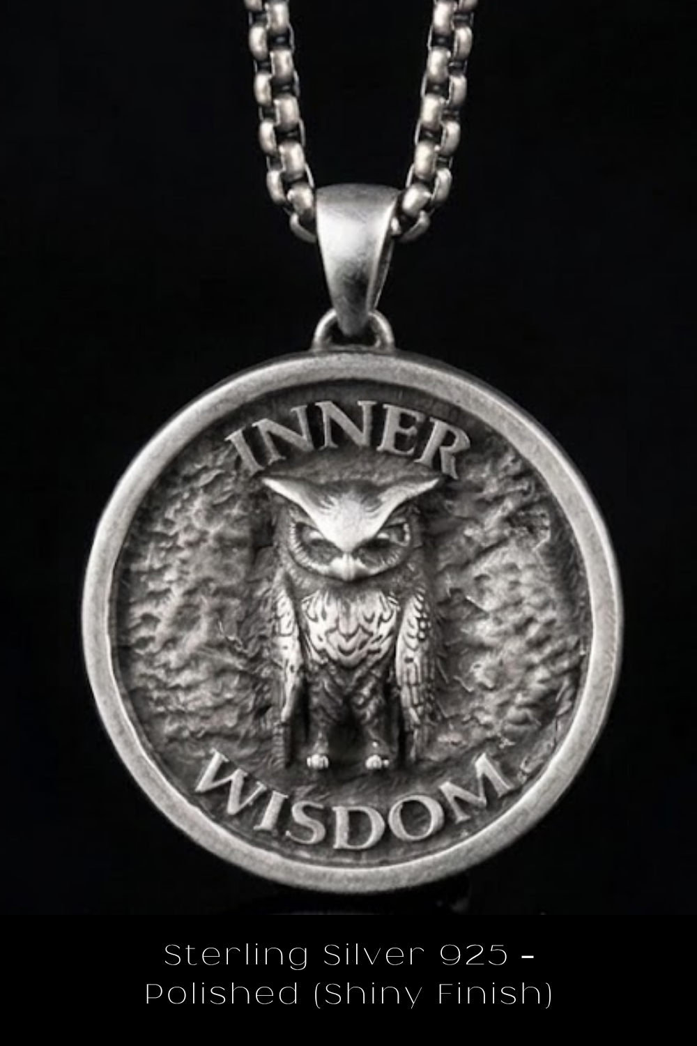 A silver pendant with an owl design, featuring the text "INNER WISDOM" around the edge.