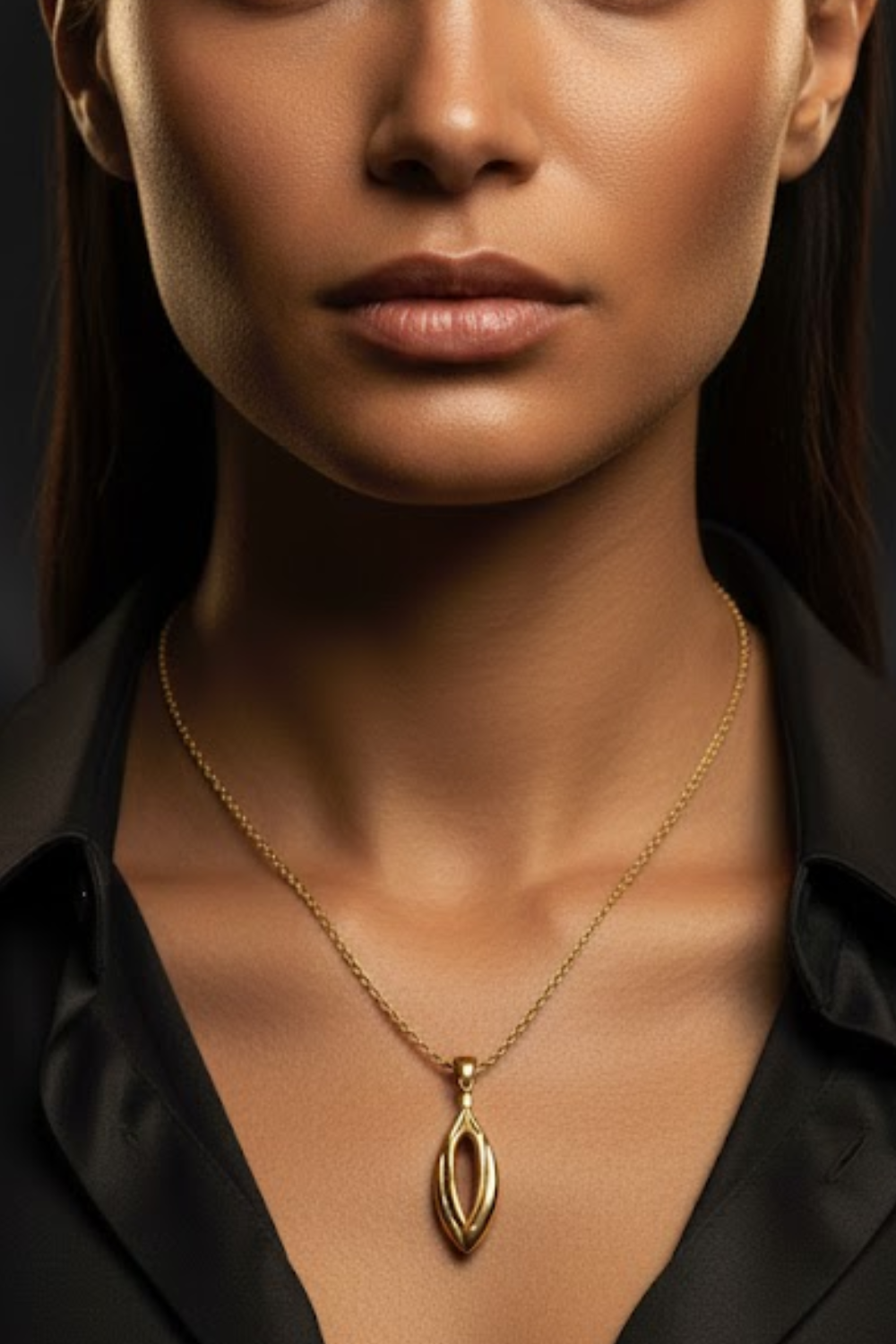 A close-up of a woman's neck and chest area, with a gold necklace featuring a pendant prominently displayed.
