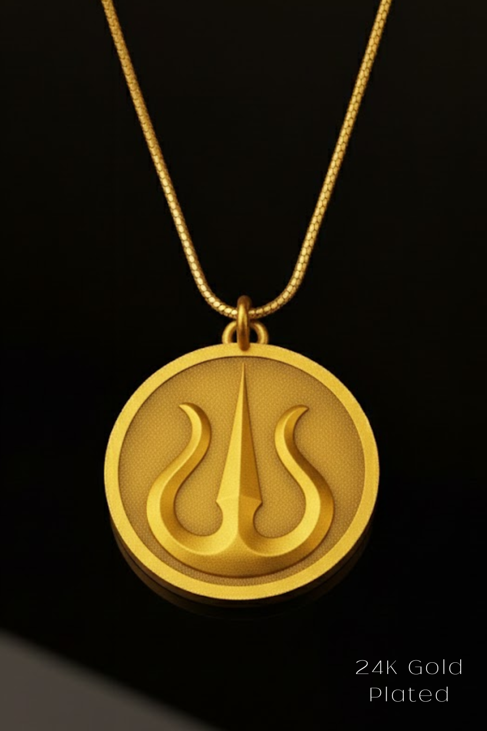A gold-plated pendant necklace with a circular medallion featuring a stylized symbol.