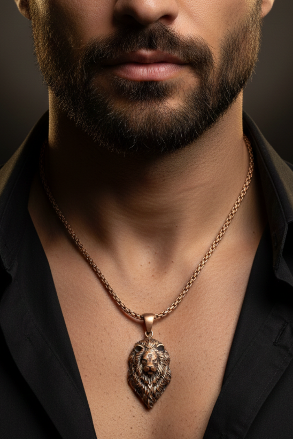 A close-up of a man's neck and chest area, with a gold-colored necklace featuring a pendant with a lion's head design.