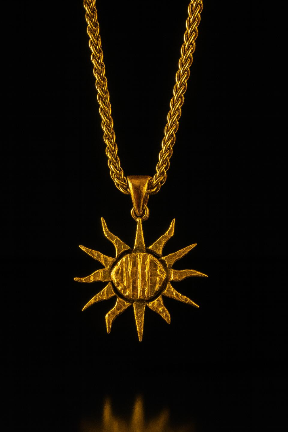 A gold-colored pendant necklace with a sun-shaped pendant is displayed against a black background.