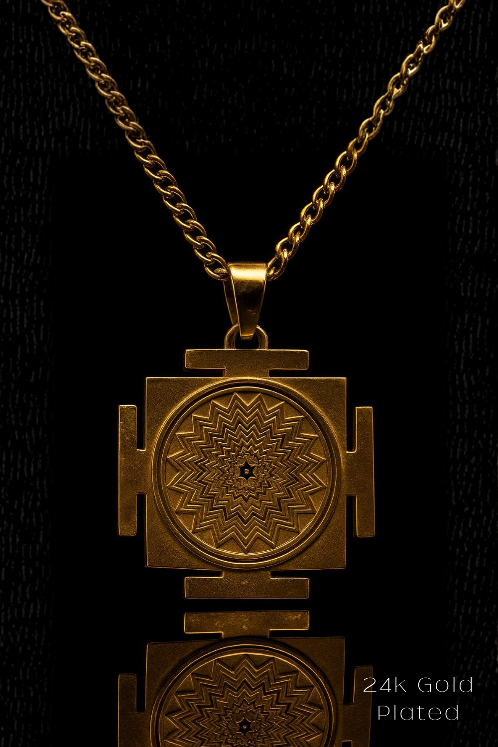 A gold-plated pendant necklace with a geometric design on a black background.