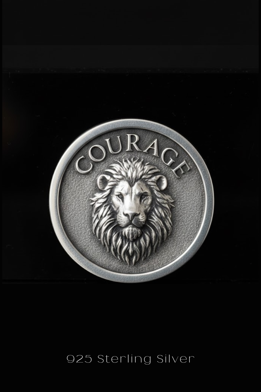 A silver coin with a lion's head and the word "COURAGE" embossed on it.