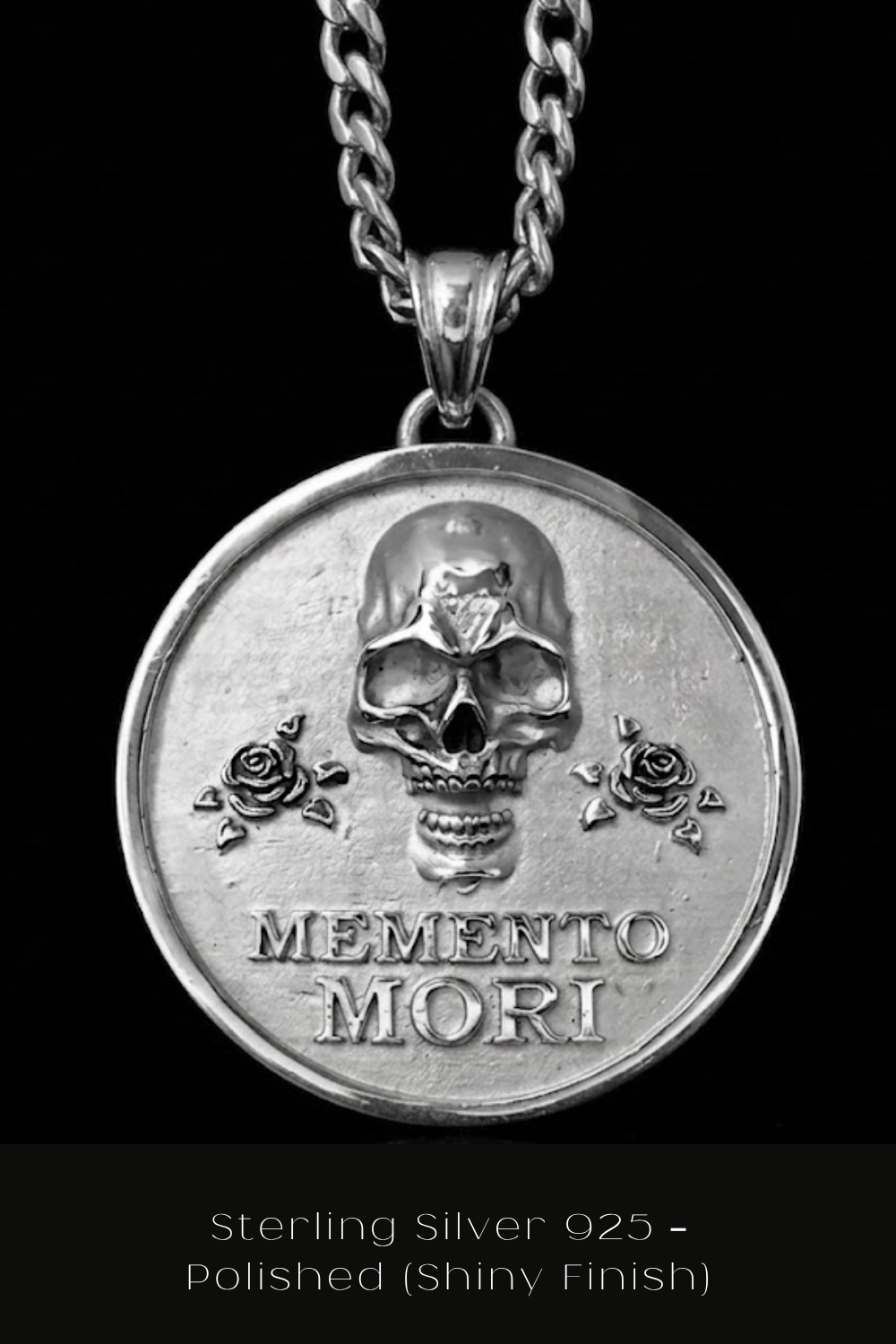 A silver medallion with a skull design and the text "Memento mori" on it, which means "Remember, this is life, not death" in Latin.