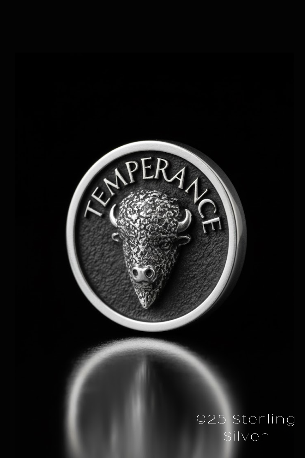 A close-up of a silver coin featuring a detailed buffalo head design.