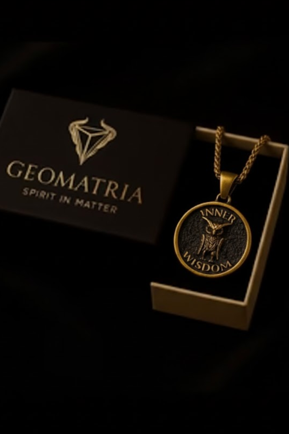 a gold-colored pendant with the inscription "INNER WISDOM" and a black circular medallion with an owl design, both displayed in a dark background.