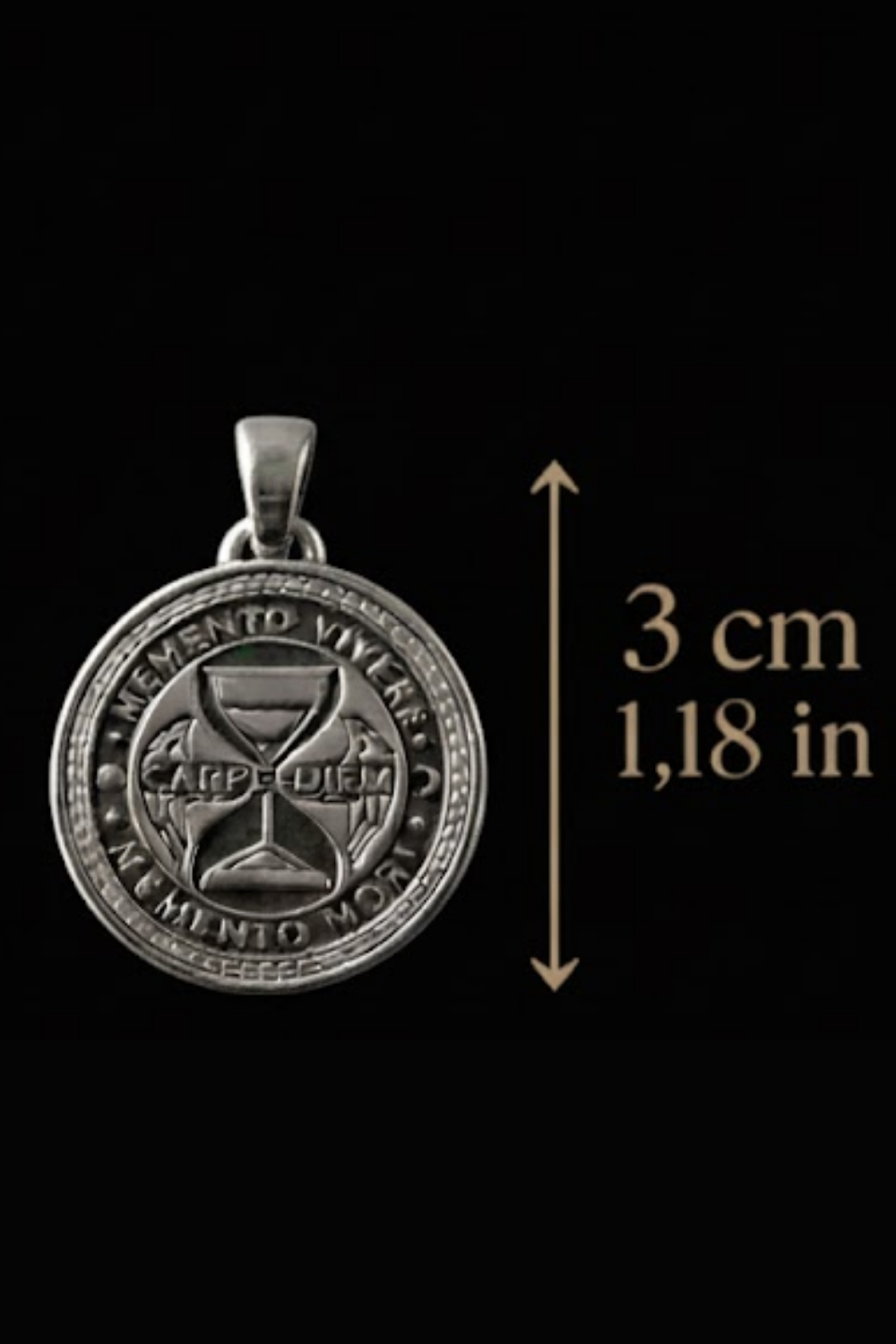 a silver pendant with a circular design, possibly a charm or a medallion, and a measurement scale indicating its size.